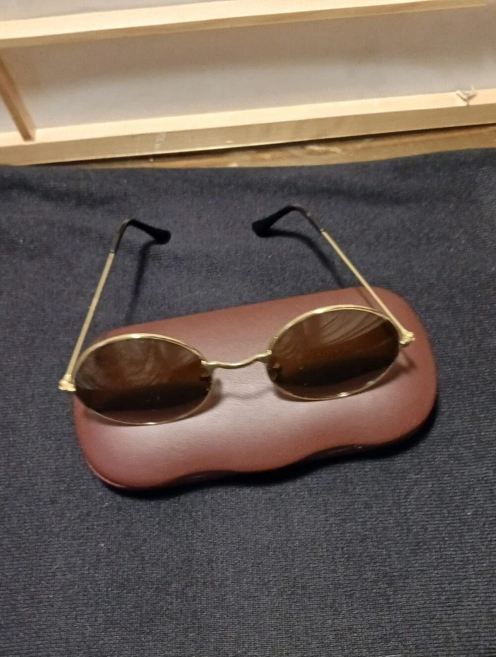 Gold Round Frame Sunglasses with Dark Glass Lenses Round Shaped.